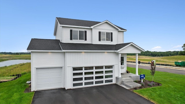 17041 Uranimite NW, Ramsey, MN 55303 - view of front facade featuring a shingled roof, asphalt driveway, an attached garage, and a front lawn