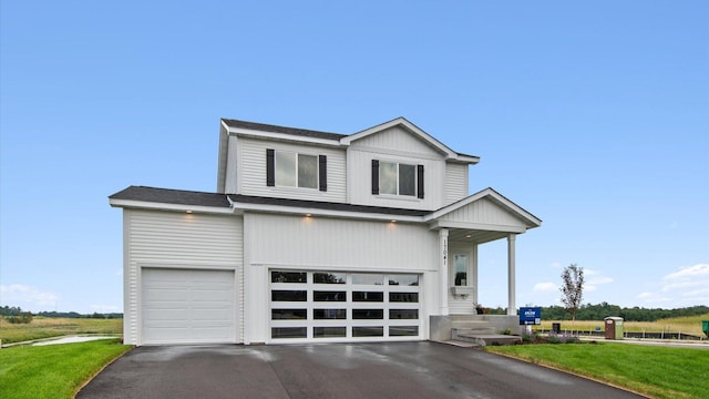17041 Uranimite NW, Ramsey, MN 55303 - view of front facade featuring asphalt driveway, a garage, roof with shingles, and a front lawn