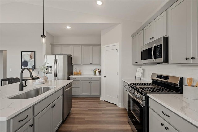 17041 Uranimite NW, Ramsey, MN 55303 - kitchen with stainless steel appliances, gray cabinets, lofted ceiling, dark wood-type flooring, and backsplash