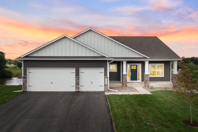 craftsman inspired home with a garage and a yard