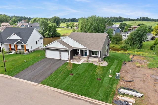 view of front of house featuring a garage, a porch, and a front yard