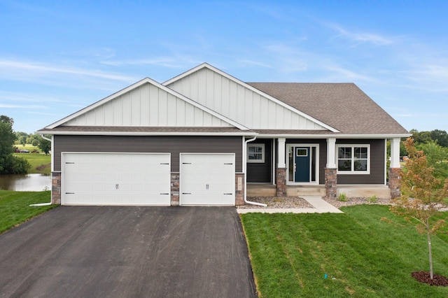 craftsman-style home featuring a garage and a front yard