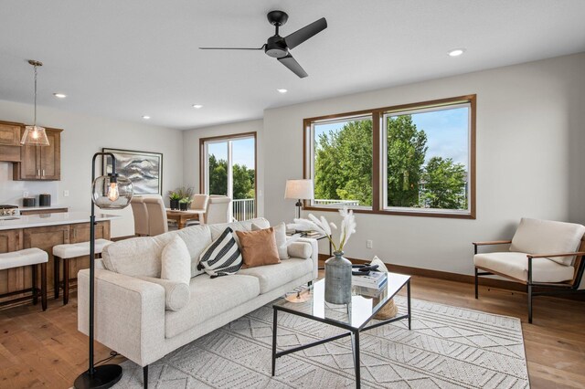 living room featuring ceiling fan and light hardwood / wood-style flooring