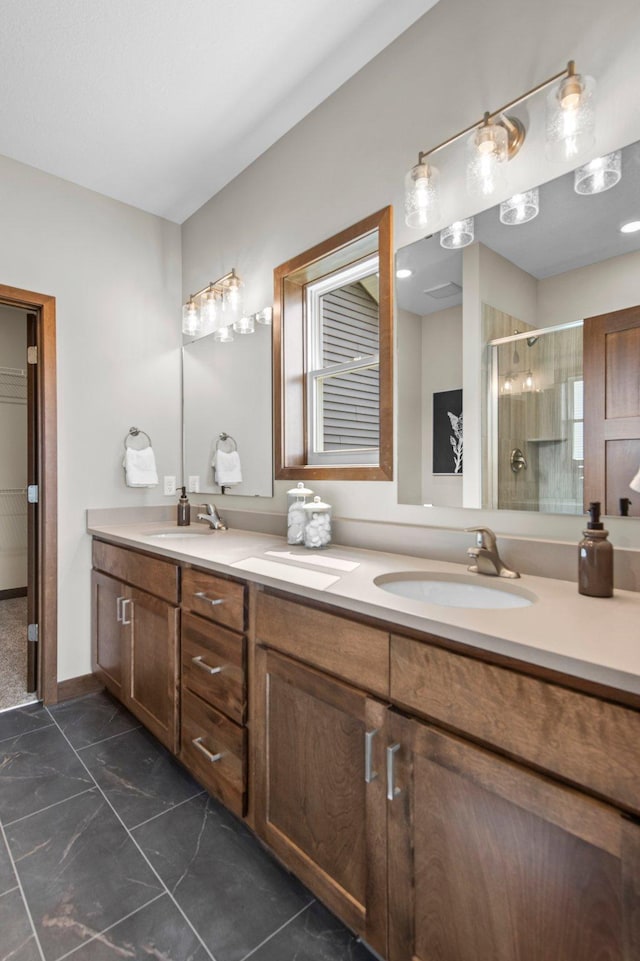 bathroom with tile patterned flooring, double sink vanity, and a shower with door