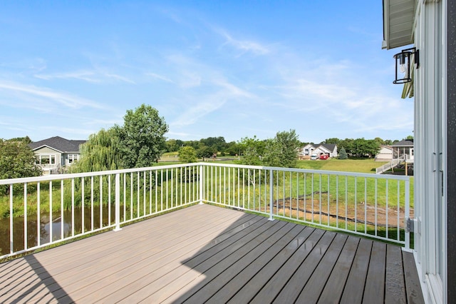 wooden deck with a lawn