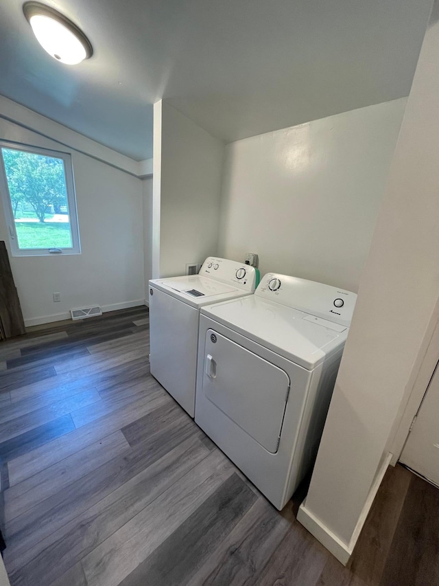 washroom featuring dark hardwood / wood-style floors and washer and dryer