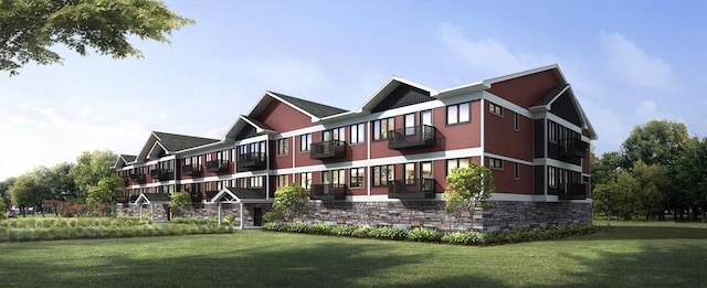 rear view of house with a balcony and a yard