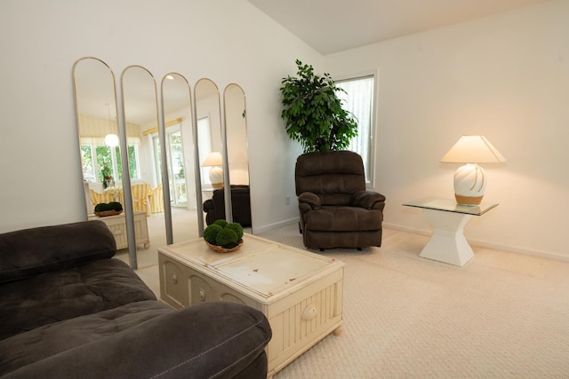 living room with vaulted ceiling, carpet flooring, and a wealth of natural light