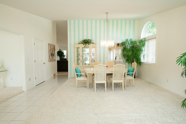 dining space with an inviting chandelier and light tile patterned floors