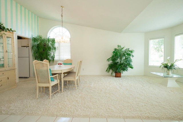 tiled dining area with an inviting chandelier