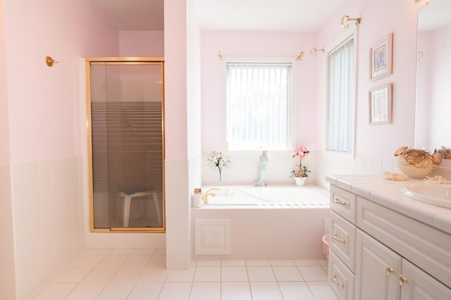 bathroom with separate shower and tub, tile patterned floors, and vanity