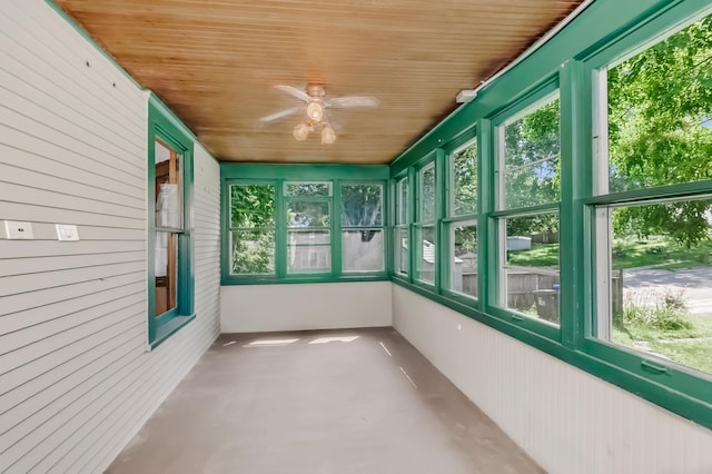 unfurnished sunroom featuring ceiling fan and wooden ceiling