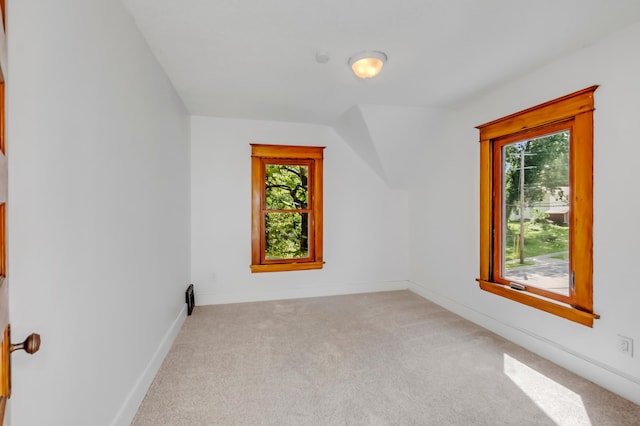 bonus room featuring light carpet and vaulted ceiling