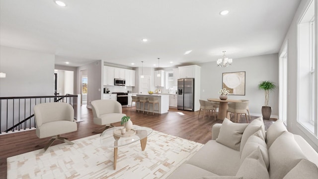 living room with an inviting chandelier, hardwood / wood-style floors, and plenty of natural light