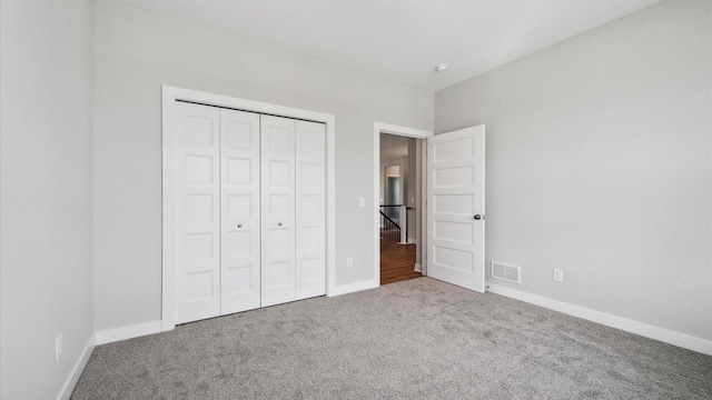 unfurnished bedroom featuring a closet and carpet floors