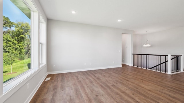 empty room with hardwood / wood-style flooring