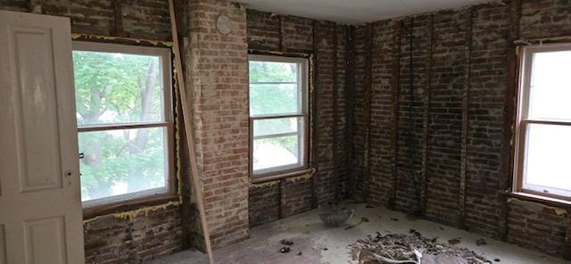 empty room featuring brick wall