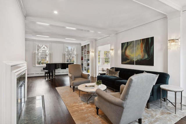 living room featuring a premium fireplace, ornamental molding, dark hardwood / wood-style flooring, and baseboard heating