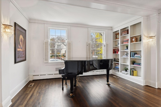 miscellaneous room with dark hardwood / wood-style flooring, a baseboard heating unit, crown molding, and built in features