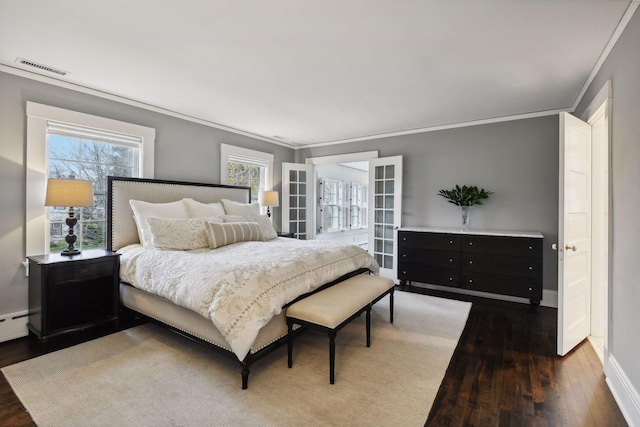 bedroom with ornamental molding, dark hardwood / wood-style floors, and french doors