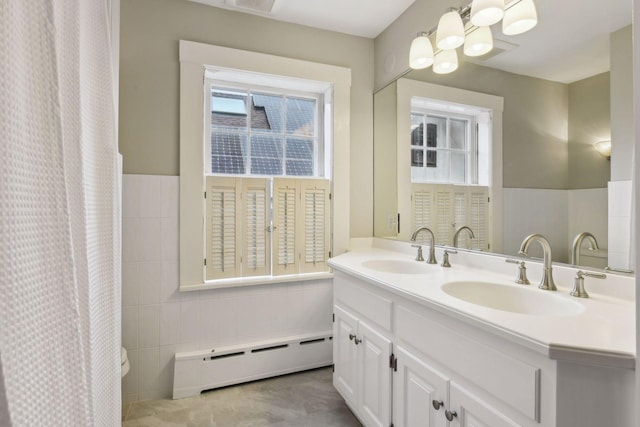 bathroom with vanity, a shower with curtain, and baseboard heating