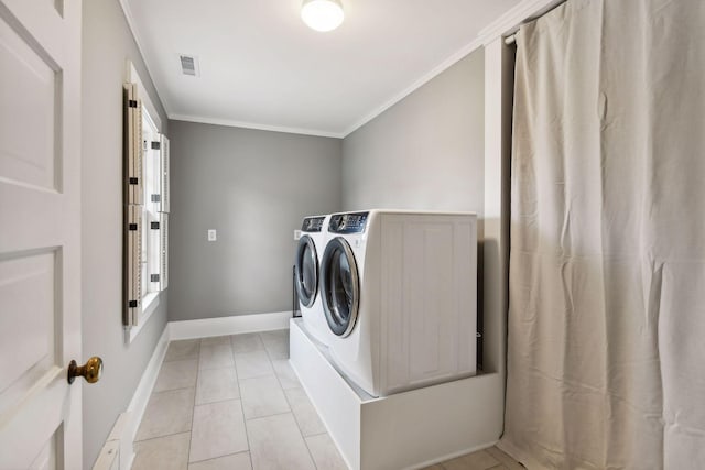 laundry area with light tile patterned floors, crown molding, and independent washer and dryer