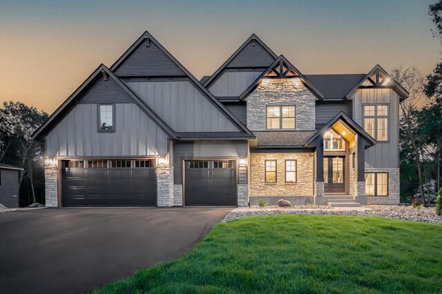 view of front of house featuring a garage and a lawn