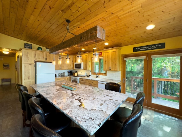 kitchen with white appliances, a healthy amount of sunlight, vaulted ceiling, backsplash, and wood ceiling