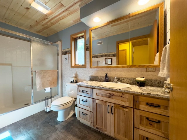 bathroom featuring vanity, toilet, wooden ceiling, a shower with door, and visible vents