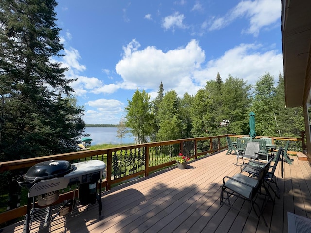 wooden terrace with a water view and a grill