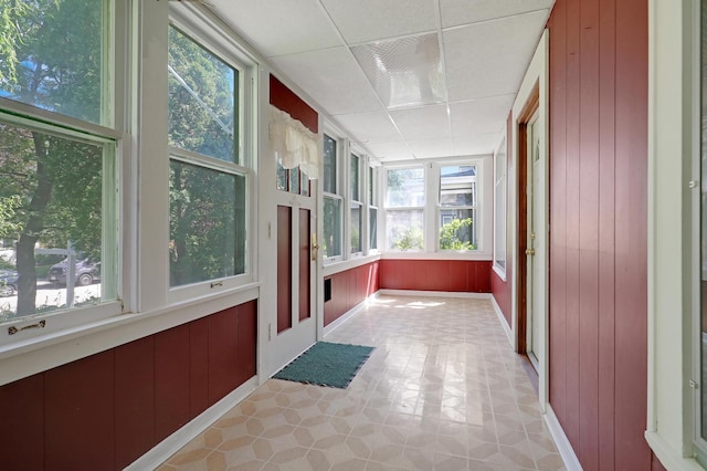 sunroom with plenty of natural light and a paneled ceiling