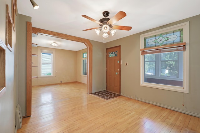 foyer with ceiling fan and light wood-type flooring