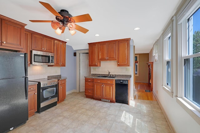 kitchen with ceiling fan, a healthy amount of sunlight, black appliances, and tasteful backsplash