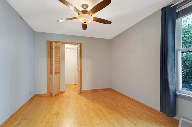 spare room featuring ceiling fan and light hardwood / wood-style flooring