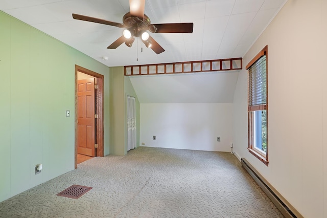 carpeted empty room featuring ceiling fan and a baseboard heating unit