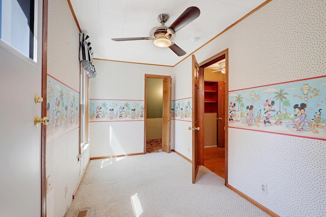 interior space with carpet flooring and ceiling fan