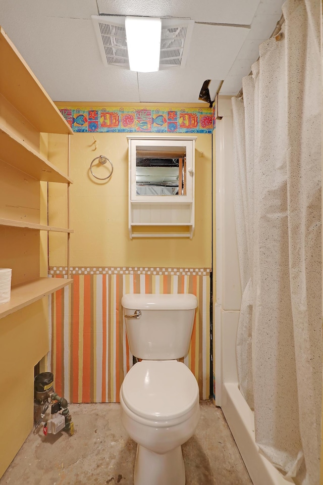 bathroom featuring toilet and concrete flooring