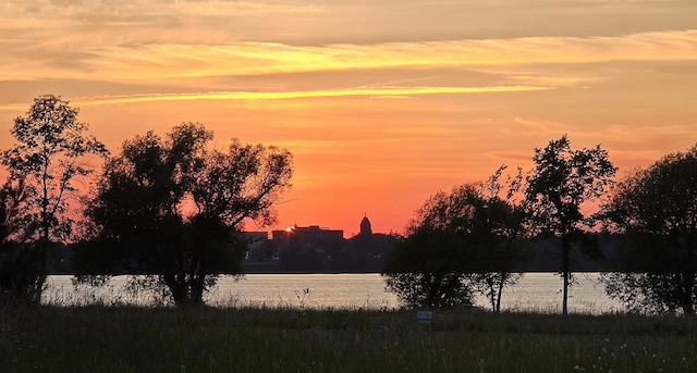 nature at dusk featuring a water view