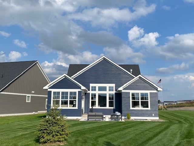 back of property featuring a patio area and a lawn