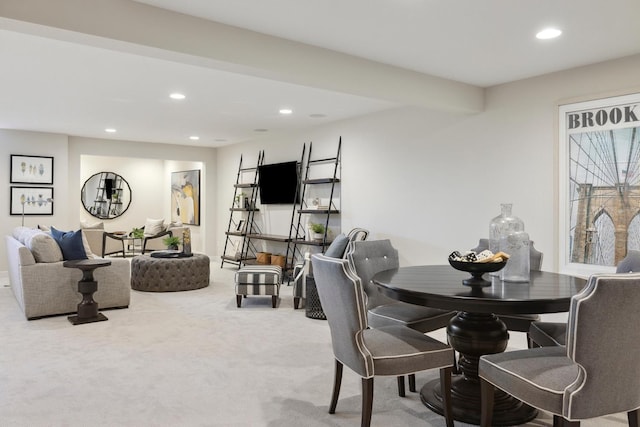 dining space featuring light carpet