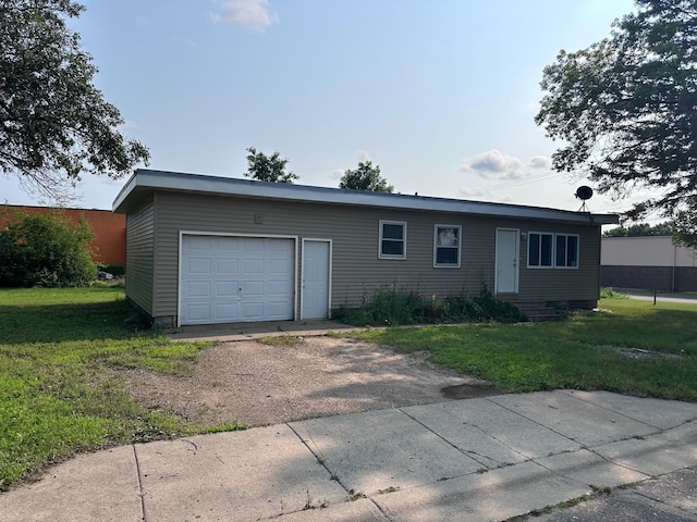 view of front of house featuring a garage and a front lawn