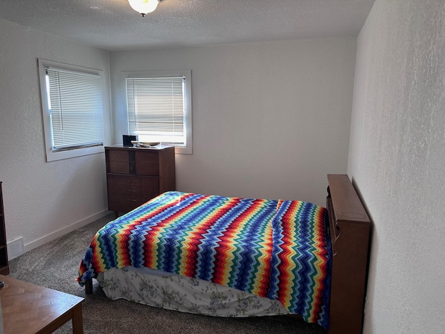 carpeted bedroom with a textured ceiling