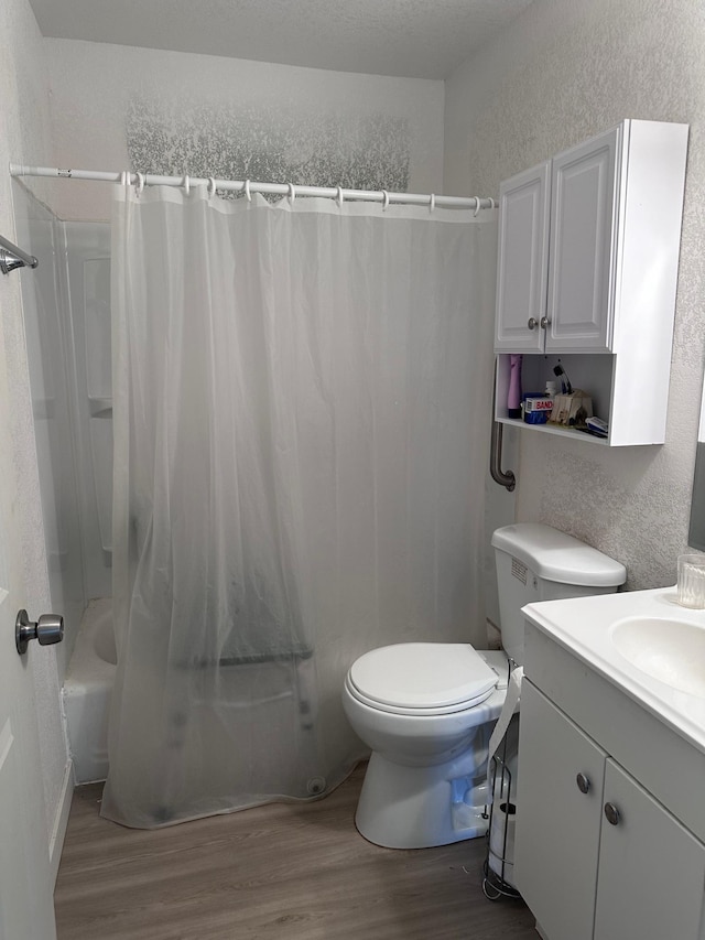 full bathroom with vanity, shower / tub combo, wood-type flooring, and toilet