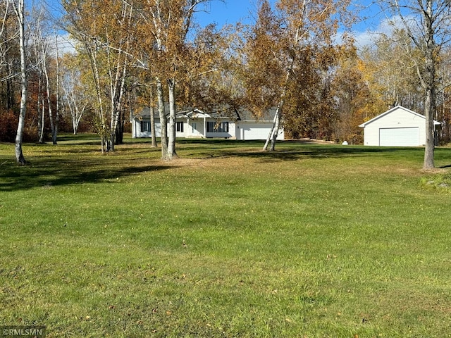 view of yard featuring an outdoor structure and a garage