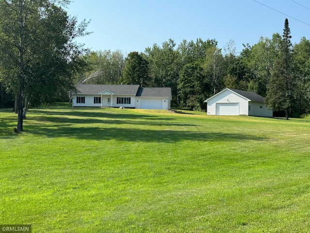 view of yard with a garage and an outdoor structure