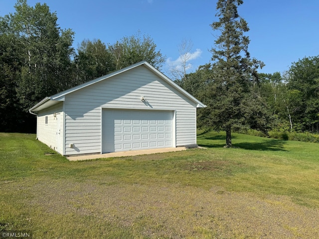 garage featuring a lawn