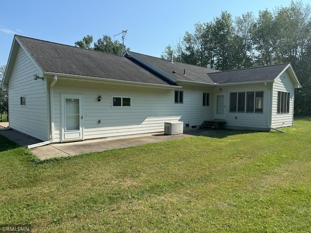 back of property with a patio and a lawn