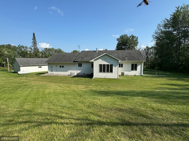 rear view of property with a lawn