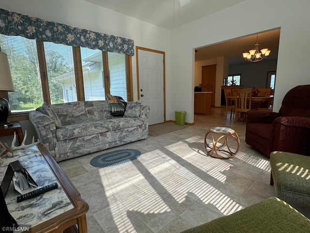 living room featuring ceiling fan with notable chandelier