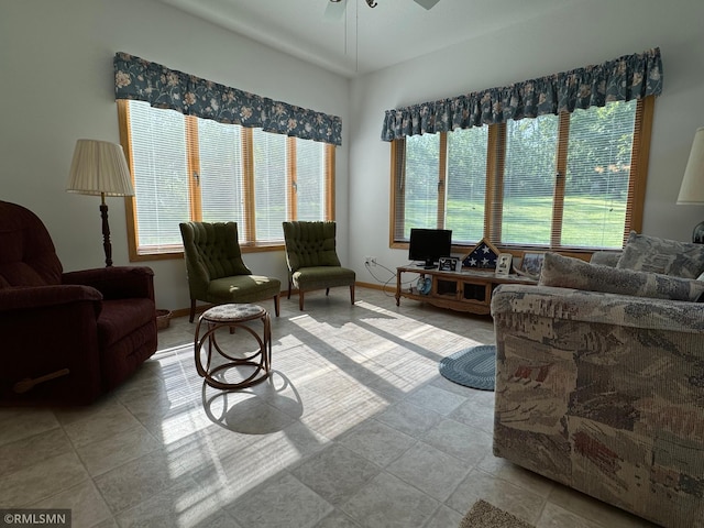 living room with light tile patterned flooring and ceiling fan